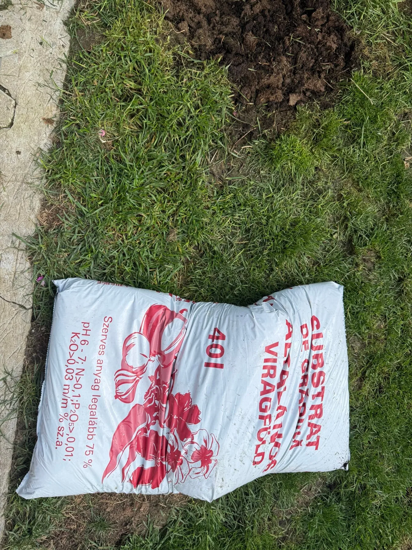 A 40-liter bag of universal flower potting mix, used on the lawn patches in the garden in Bran, Romania.